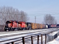 <br>
<br>
  The Multimark – it's Everywhere!
<br>
<br>
  A trio of SD40's, a dash two, a plain, & an EMD version power a westbound: CP Rail 5745 – 5532 -  Kennecott Copper Corporation #101 .
<br>
<br>
   The Hump power in the background: CP Rail 1502 – 1518 – 1516, all GP7u rebuilt renumbered from 8421 – 8539 – 8509. 1518 to JCLX 1518 in August 2014 then to Northern Plains Railroad.
<br>
<br>
  And behind the photographer is CP Rail 1534 and sister awaiting clearance to enter the yard.
<br>
<br>
   Saturday morning at McCowan, December 21, 1985 Kodachrome by S.Danko, and there is that CPR script water tower....
<br>
<br>
   More McCowan: 
<br>
<br>
     <a href="http://www.railpictures.ca/?attachment_id=  6317 ">  The Empress </a>
<br>
<br>
