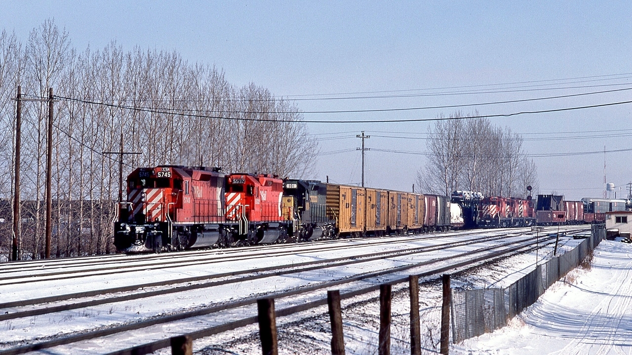 The Multimark – it's Everywhere!


  A trio of SD40's, a dash two, a plain, & an EMD version power a westbound: CP Rail 5745 – 5532 -  Kennecott Copper Corporation #101 .


   The Hump power in the background: CP Rail 1502 – 1518 – 1516, all GP7u rebuilt renumbered from 8421 – 8539 – 8509. 1518 to JCLX 1518 in August 2014 then to Northern Plains Railroad.


  And behind the photographer is CP Rail 1534 and sister awaiting clearance to enter the yard.


   Saturday morning at McCowan, December 21, 1985 Kodachrome by S.Danko, and there is that CPR script water tower....


   More McCowan: 


       The Empress