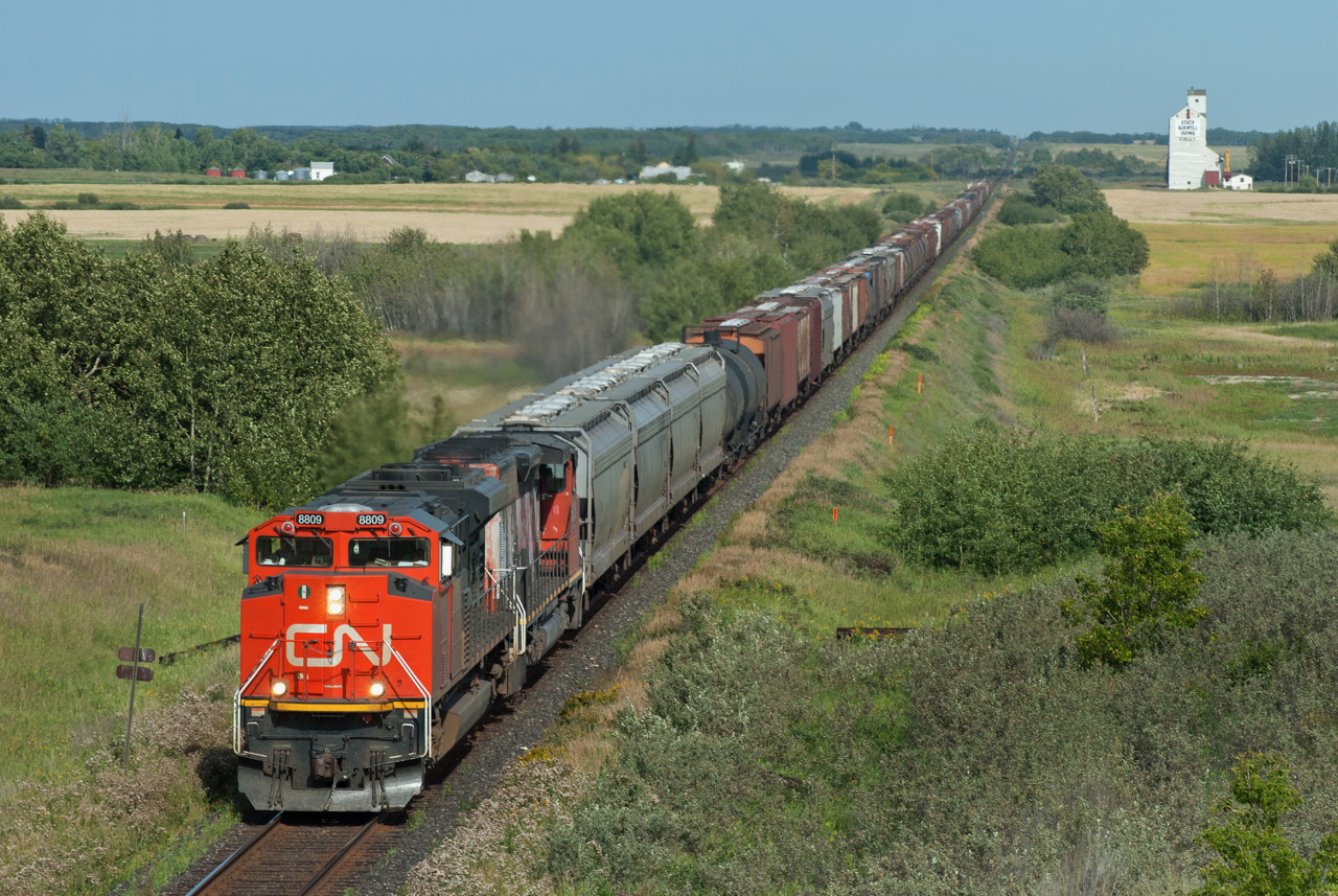 CN 8809 West passes the small village of Kinley Saskatchewan. While Kinley is no longer an identifiable location on the CN time table, it's name beginning with a K is no coincidence as it is situated between sidings Juniata and Leney on the former "alphabet railroad" better known as the GTP.