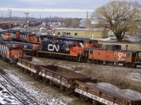 For a number of years no trip to Niagara Falls would be complete without a visit to CN’s yard in town. It seemed like there was always some kind of interesting power there, and this day probably had the most variety I had ever seen in the yard. By this date GP9’s and GP38’s had replace the old SW1200’s that previously were in charge of the locals and yard jobs stationed here. Road power for 448 and 338 also often laid over here. It is hard to believe CN once had three main yards in the Niagara region.  Fort Erie even had a large engine house but was the first yard to close. By this date Niagara Falls yard was still fairly busy but traffic here was definitely thinning out. A decade or so later and the yard here too would be history with all remaining Jobs assigned to Port Robinson. Today CN no longer assigns four axle power to the region and six axle power runs all locals. This day there was a slug set used for the yard work while the two GP38’s handled all other local assignments. Road power included a SD50AF, SD60, an original non Dash-2 SD40 and a rebuild  SD40U. I miss hanging out on the old road bridge over the end of the yard here. All that remains is the mainline and the yard office. 