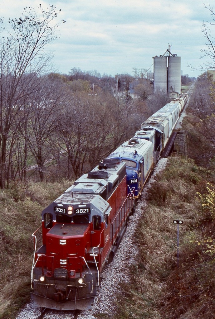 For a period of time GEXR train 581 was very predictable for motive power, with GP38 3821, the two FP9’s 1400 & 1401 and GP9 4001. Typically the “F” units were considered as “B” units and rarely led trains unless there was no other leader available. Unfortunately as their age took its toll the two “F” units eventually were sidelined for good. Thankfully OSR would save them from becoming scrap. Nevertheless train 581 was always a good catch and chase. This day as the weather deteriorated I chased train 581 westward from Stratford, unfortunately one of the “F” units was out of service but the train was still a nice sight rumbling over the creek in Mitchell and ducking under one of the few road bridges along the line.