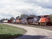 A CN, all in the family lash up with CN SD75 5698, IC SD40A 6017, WC SD40-2 6005 (ex Algoma Central) and GTW SD40-3 (ex KCS, nee CN)  rolls east of Woodstock VIA station at s location the was once a junction with a branchline that once ran both north and south of town to connect a number of smaller towns. The line was removed decades ago. It would appear I was luck to find a break in the clouds as this train approached. 