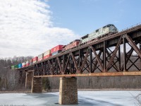 CP 132 (9-132) leads an extra train bound for Montreal, with Military unit CP 7022  up front, as it crosses the Mudlake Trestle, in Bolingbroke.