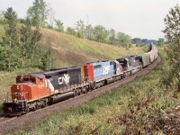 This by far was one of my favourite early on railfan spots. A number of us used to meet up at mile 30 typically on Sunday just to take in some action. The hike up the hill where the golf course now is was always worth while with nice scenic shots in either direction. One could easily spend an afternoon here and we often did. Unfortunately with the Pro Links golf course on either side of the tracks today along with a bridge to the east of this shot, it is not quite the same here anymore not to mention how much greener has filled in the location eliminating this angle completely. I’m glad I spent the time I did here. This train was an interesting one as it was a rare unit grain train that started out with another IC SD70 in the lead. Unfortunately it was replaced by 5340 in Sarnia. This still made for a nice mix of power and it was always nice catching the DWP units in any consist. I never photographed from the hill on the other side as the lighting never worked but looks like it would have made a nice shot on an overcast day. 
