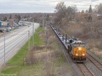 CN X388 is highballing through the outskirts of Kingston following Bath Rd. Upfront is CSXT 985 solo hauling 72 empty windmill blade cars, bound for Gaspe QC.