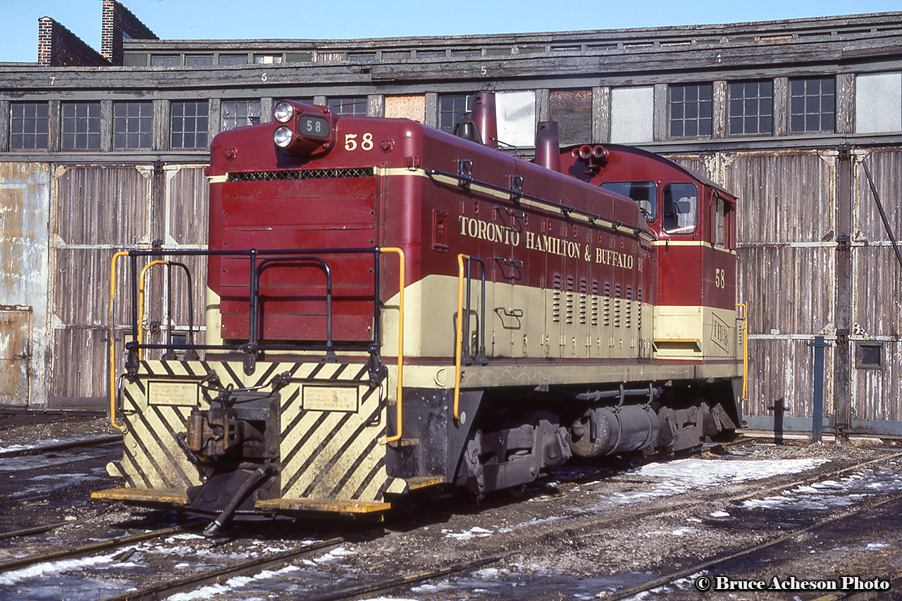 TH&B SW9 58 rests at Chatham Street Roundhouse.  Built at GMD London in January 1951, the 58 would be sold to Atlas Steel for scrap in May 1988, but would avoid the torch, being sold to the Brandywine Valley Railroad in Pennsylvania as BVRY 8206.  It would be transferred to the nearby Upper Merion & Plymouth Railroad as UMP 9007 in 1991, where it was operating as recently as 2017.