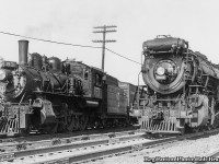 A scene at Hagersville finds CNR 2-6-0 Mogul 83 working the CNR/NYC interchange to the north west side of the <a href=http://www.railpictures.ca/?attachment_id=29044>Hagersville diamond</a> while a New York Central Mikado makes it's way westbound towards St. Thomas and beyond.  Note the CASO lettered boxcar behind 83.<br><br>CNR E-10-a 83, built by CLC in 1910 as Grand Trunk E12 class mogul 1003, renumbered to CNR 905 in 1923, and to CNR 83 in 1951.  It would be scrapped in January 1959.  NYC H7c, 2-8-2 Mikado 2016, built as Michigan Central 7916 by ALCO in 1913, would receive it's current identity in 1936.  It would be retired in February 1956, disposition unknown.  It was one of 28 H7s assigned to the Canadian Division.  More info on the H7s, including images at St. Thomas and Welland, can be found <a href=https://nycshs.files.wordpress.com/2014/03/h-7mikados.pdf>in this article by the New York Central System Historical Society.</a>