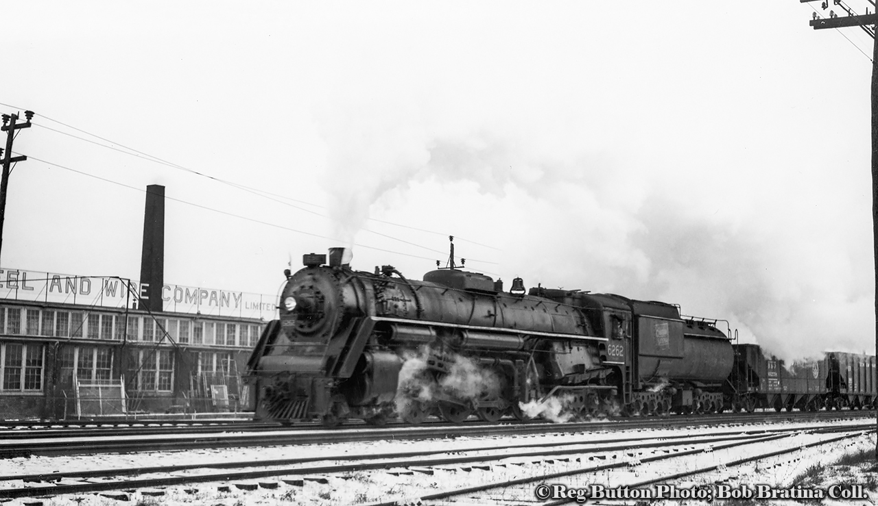 Snapped just east of Lottridge Street, CNR northern 6262 brings a freight into Hamilton from the Niagara region, passing alongside Frost Steel & Wire Company Limited.  6262 was the third last Northern built for the CNR, being one of thirty U-2-h class locomotives built by MLW in February 1944.  It would be scrapped just sixteen years later in February 1960.Frost Steel & Wire, founded by Henry L. Frost, began their operations in Welland in 1898.  The company moved to Hamilton in 1904, with their site at the corner of Sherman Avenue and Princess Street.  They would expand over the coming decades, eventually giving them the entire block on Princess from Sherman to Lottridge Street.  In 1926-27 the company would expand across Lottridge Street, purchasing the R. A Lister & Company Limited property on the north side of the CNR Grimsby Sub for their head office (250 Lottridge) and further manufacturing.  An old loading dock remains today alongside the railway and can be seen in a 50th anniversary promotional image found here.  Frost would shut it's doors in 2002, but it's former head office building still retains the Frost Steel & Wire Products Limited sign on the south side facing the railway.
