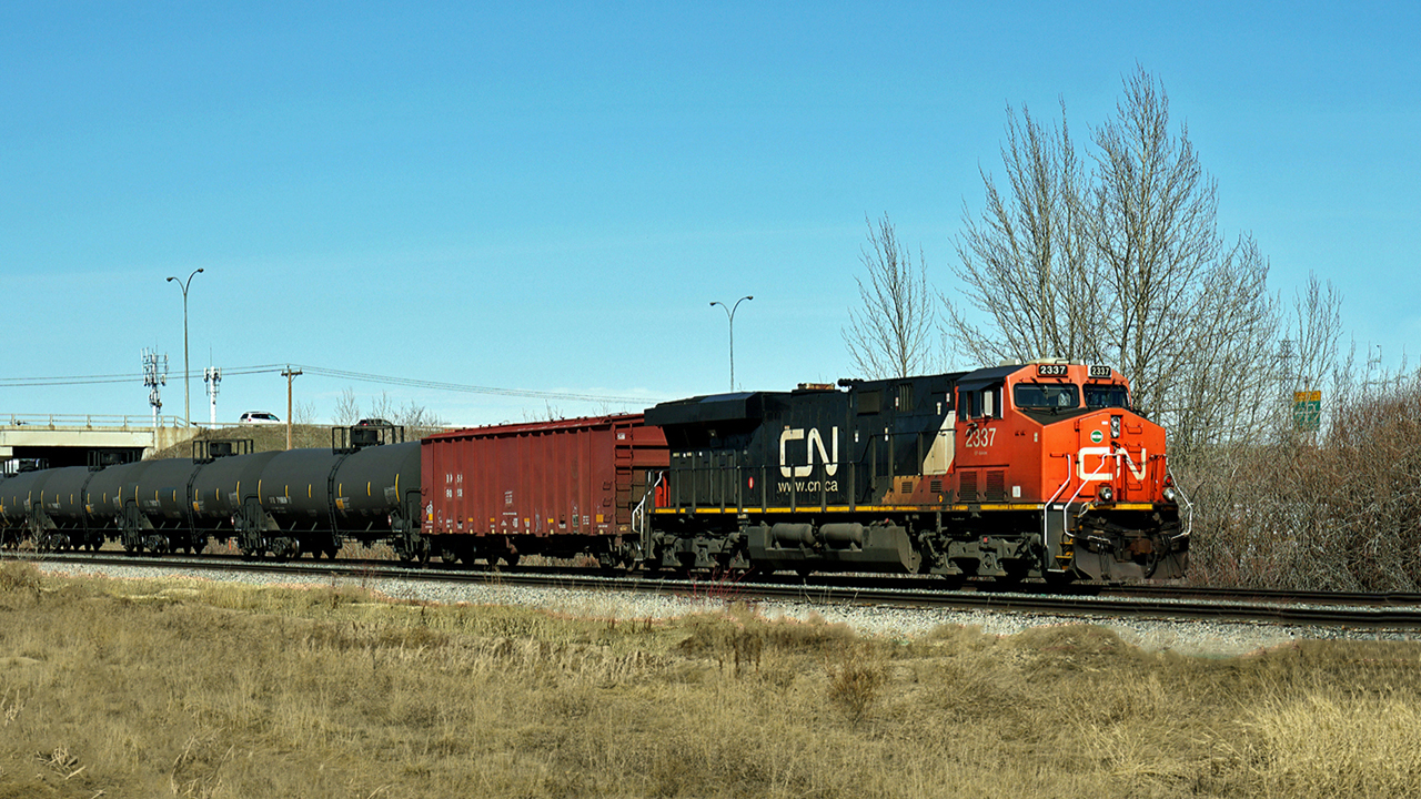 ES44DC CN 2337 makes its way south on the Camrose sub taking an oil train to the Kinder Morgan/Pembina loading facility.
