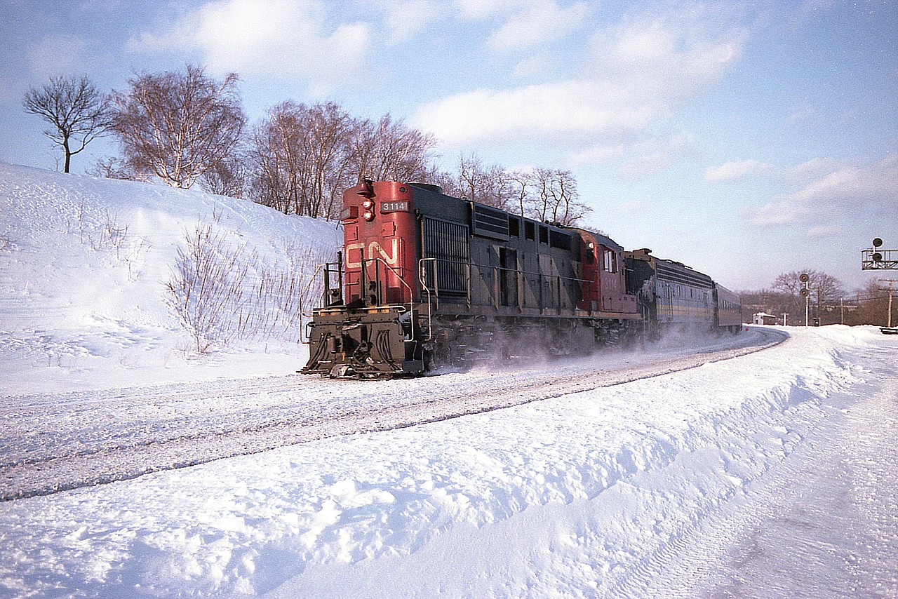 I've not posted a snowy winter scene in a while, so here goes.  Thankfully the Bayview Jct "parking lot" was plowed out enabling me to at least get up into location.  This is mid-afternoon, around 1500 hrs and the westbound VIA with CN 3114 and VIA 6621 is about to ascend the long Copetown Hill on its way to London/Sarnia.
Yes. It was bitter and the sun didn't help matters all that much.