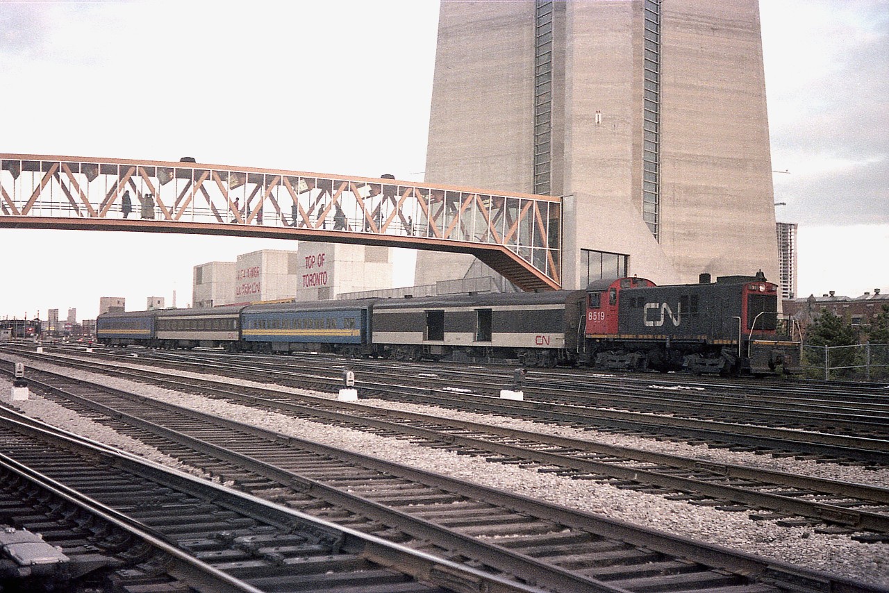 Seen here by the base of the at-the-time new CN Tower, MLW S-13 #8519 moves around a cut of passenger coaches.
When the passenger maintenance centre was at Spadina before relocating to Willowbrook; these locomotives were instrumental in keeping the passenger equipment organized.