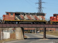 Just following the footsteps of others on this site, Iron Oxide red everywhere and the CN 07:00 continues that theme as 4762, 4710 and 7038 switch above busy Birch Avenue during a sunny afternoon in the Hammer’s industrial area.  