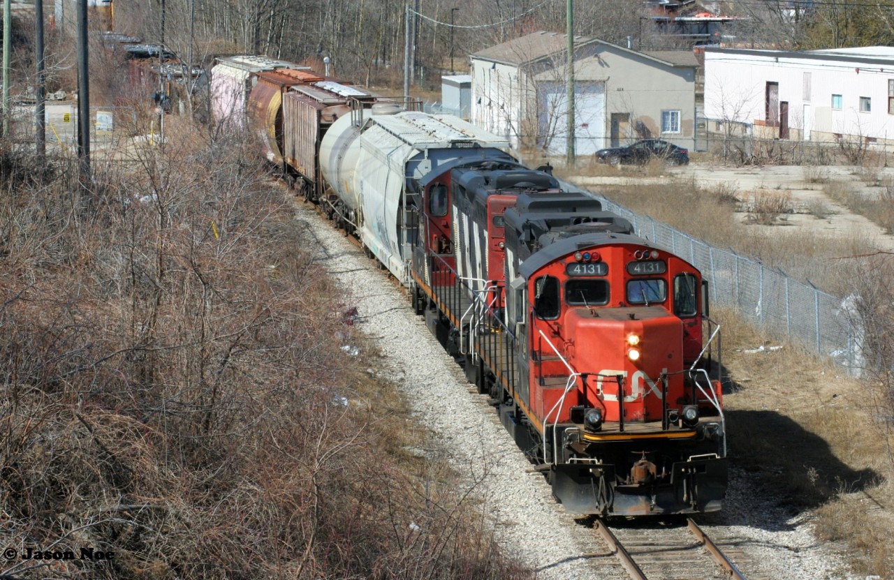 CN L568 with vintage GP9RM's 4131 and 4130 are viewed shoving back to the Guelph Subdivision in Kitchener, Ontario on the Huron Park Spur returning from the interchange with Canadian Pacific at South Junction from the Stirling Avenue bridge.