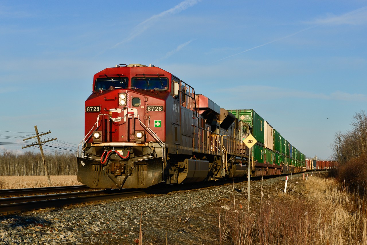 CP 133 throttles up as it departs Smiths Falls. Clear skies would blind the crew for part of the trip as they head west for Toronto. In trailing position is CP 7010, one of ten SD70ACu's sporting a heritage livery.