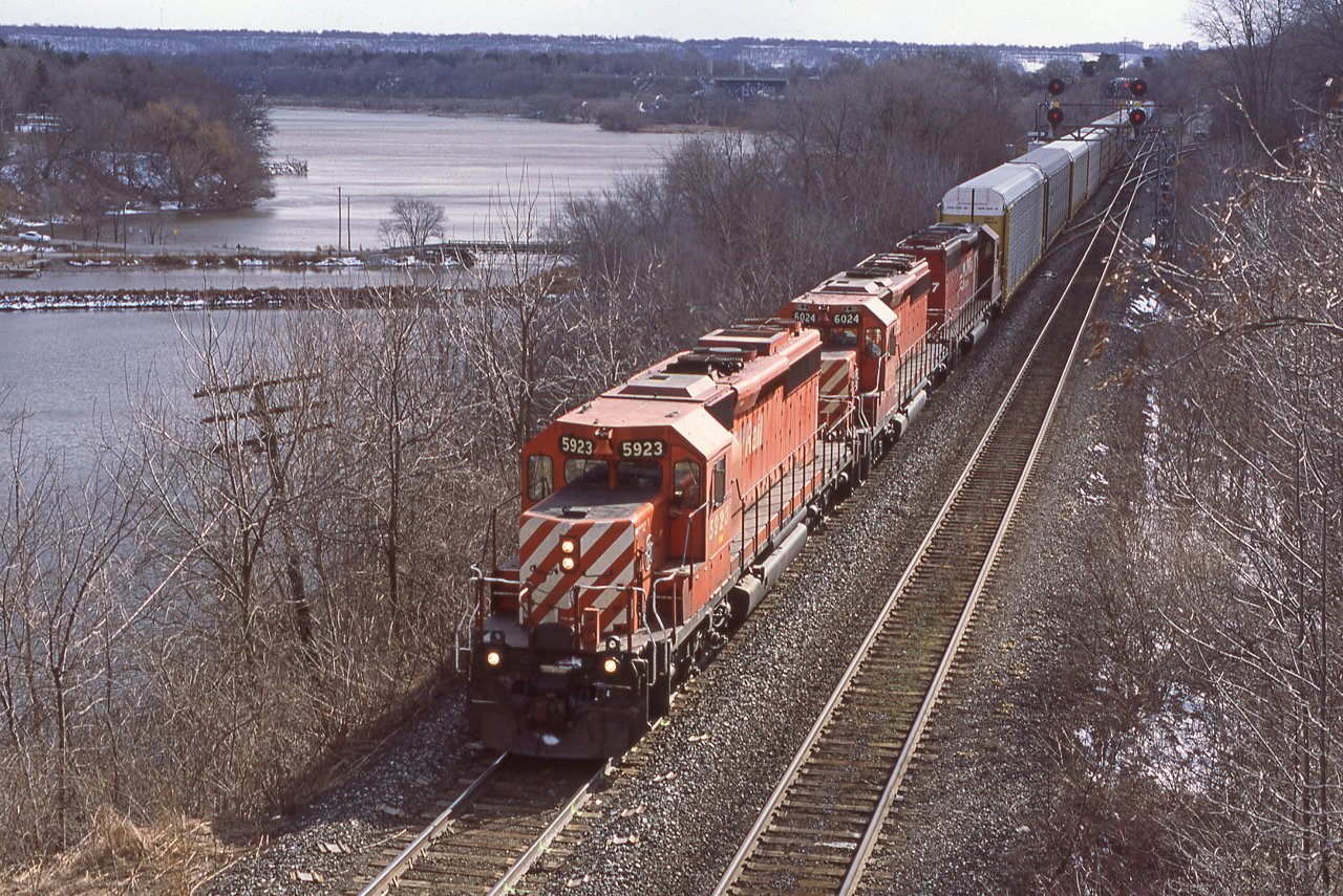 This scene has certainly changed over the rears since this slide was exposed.  A trio of same old same old CP SD40-2s exercise trackage rights on the CN Oakville Sub beneath the foot bridge at Bayview on a march afternoon.  Oddly enough, the sun decided to pot out just as the power passed by.