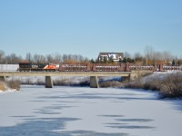 CN GE ET44AC #3262 leads CN L562 long hood forward back towards Port Robinson over the Welland River after interchanging with Trillium Railway at Feeder Yard.