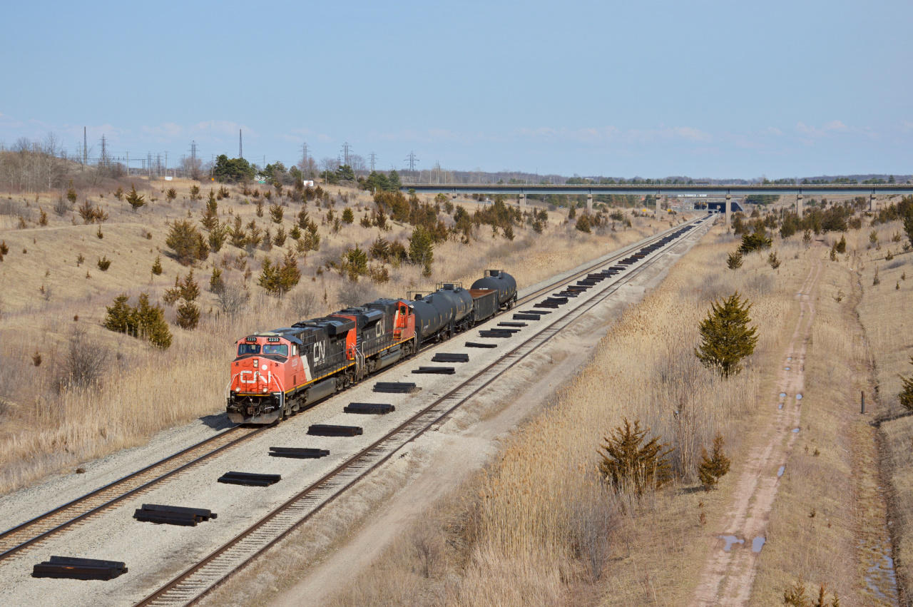 CN L562 led by CN ES44DC #2235 heads towards Trillium's Feeder Yard along the CP Hamilton Subdivision. This section is famous for its recognizable trench section which was dug out to go under the Welland Canal.