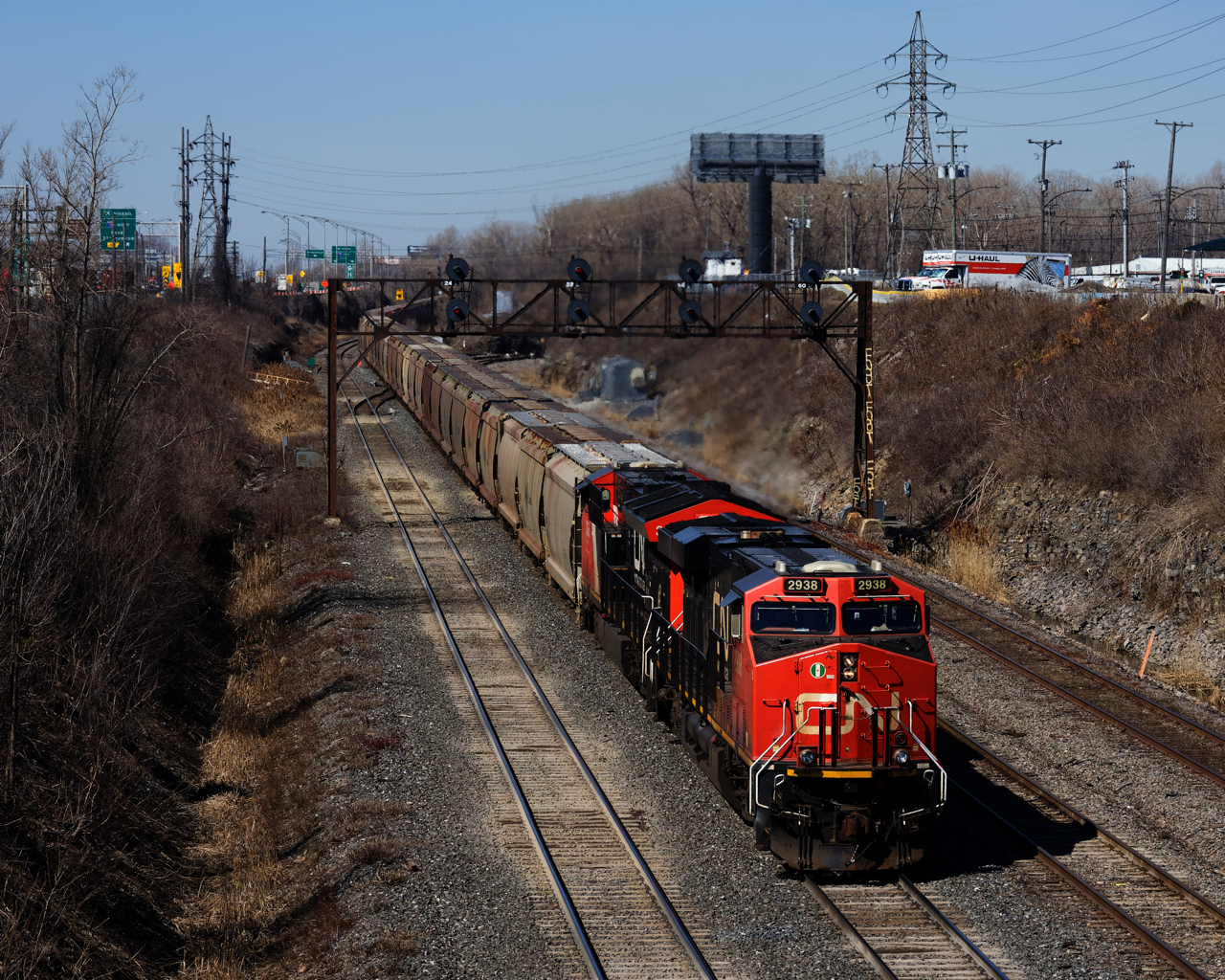 CN B730 has about 30,000 tons of potash for Saint John, New Brunswick as it passes underneath a vintage signal bridge. VIA 65 is lined on the south track and will pass underneath me a split second after this photo was taken.