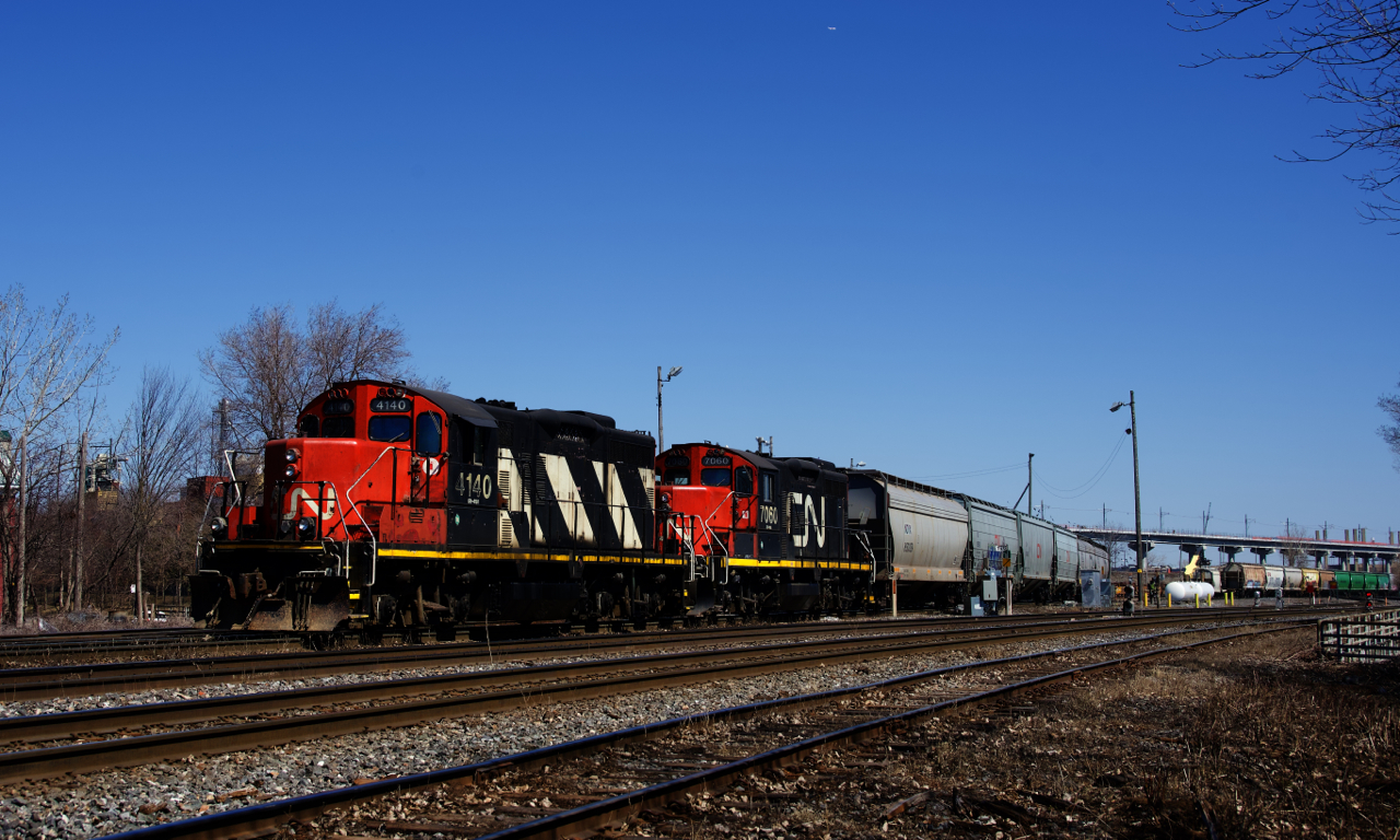 The Pointe St-Charles Switcher has just arrived at it namesake yard from the Port of Montreal and is shoving eight cars from there into the yard with CN 4140 & CN 7060 for power.