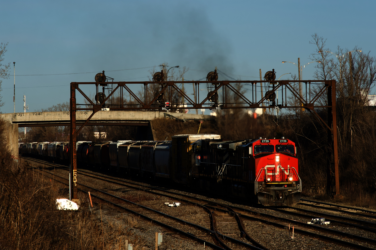 CN 527 is approaching Taschereau Yard with IC and BCOL Dash9s for power (IC 2726 & BCOL 4651) as it prepares to cross over from the north track to the freight track.