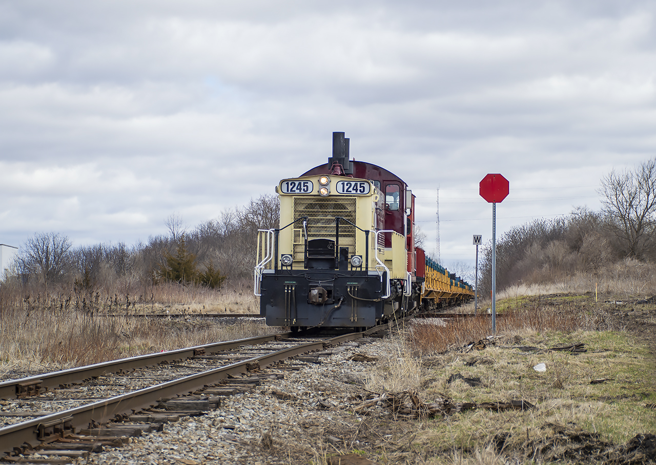 In response to trackwork on the CN Talbot Sub, OSR has been handling automotive frames from the Formet plant at St. Thomas to CN at Beachville rather than the usual direct CN routing.  Arriving with 16 empties, OSR shoves across the diamond towards the plant with it's second chunk of 8 cars, where it will wait for L583 with CN 4730 to arrive to pull the loads for them.