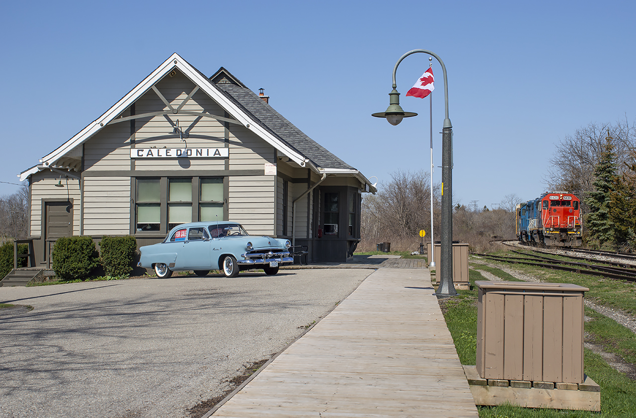 A pair of blues pull ahead to clear the switch for Nicholson & Cates while a 1953 Ford Mainline basks in the sunshine at the old station.  The Ford is up for sale.  I didn't get a price but it is in mint condition inside, outside, and under the hood.