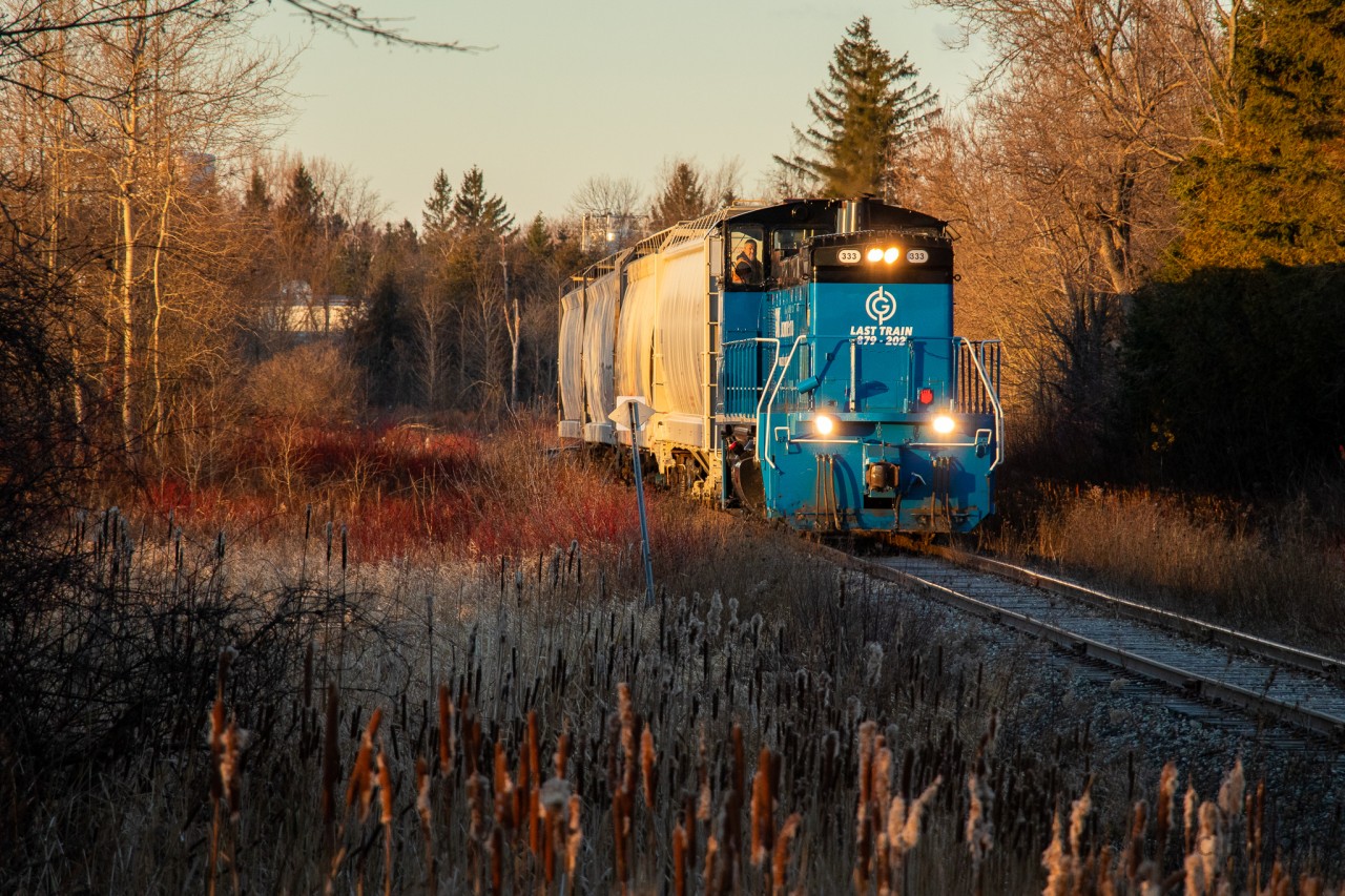 The sun rises on the final day...
GMTX 333 has finished lifting the final 4 hoppers from industries in Orangeville and is seen making its way south towards the yard before they begin the trip southbound to Streetsville.

As of April 1st 2022, the tracks in this photo have been completely ripped up as the city of Orangeville wants a functional trail by summer 2022. I wish it was an April Fools joke. :(