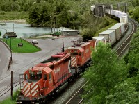 Eastbound time freight 402 has just crossed the east arm of the Winnipeg River at its intake with the Lake of The Woods. The train is approaching the station where a crew change will take place