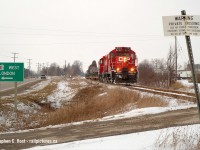 The Sprint Train, as it was also known, passing through Putnam and framed in some signs, railway and non. Nearly done for the day, they're wasting no time doing all of track speed (25 MPH) heading to St. Thomas with only 30 minutes to go. It was <a href=http://www.railpictures.ca/?attachment_id=48509 target=_blank>really neat seeing OSR do the same thing</a> a few weeks ago. Here's hoping that CP can win the business and OSR can haul it again.