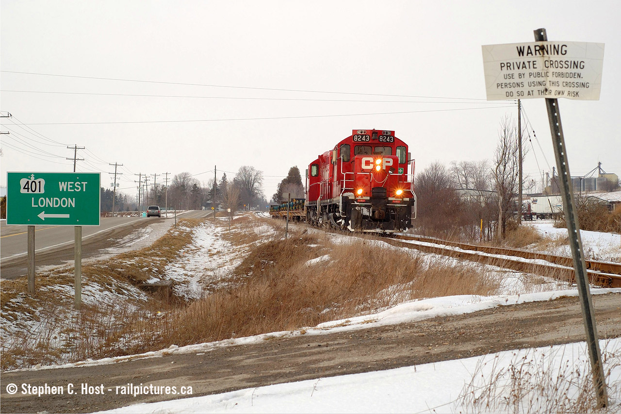The Sprint Train, as it was also known, passing through Putnam and framed in some signs, railway and non. Nearly done for the day, they're wasting no time doing all of track speed (25 MPH) heading to St. Thomas with only 30 minutes to go. It was really neat seeing OSR do the same thing a few weeks ago. Here's hoping that CP can win the business and OSR can haul it again.