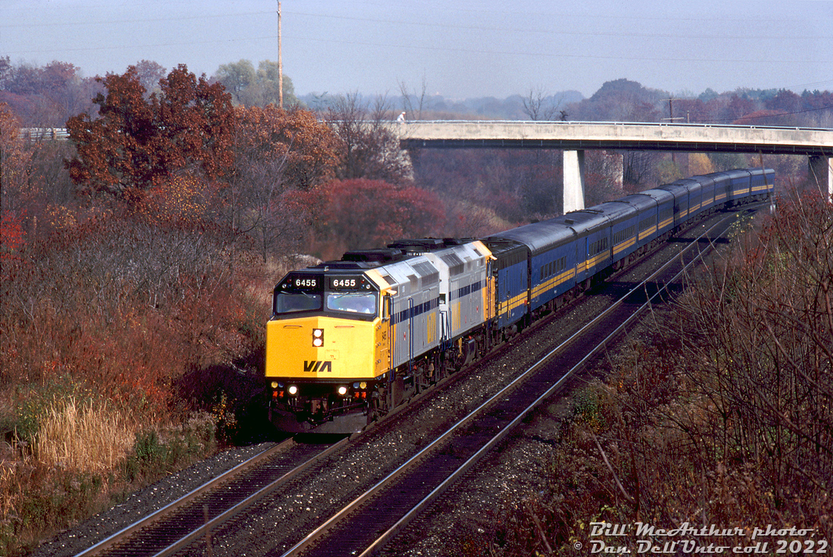 New VIA power? In 1989 that meant more modern HEP-equipped 3000 horsepower F40PH-2D locomotives! At the time a third order of units were being cranked out by GMD London for VIA (6430-6458), and one of which, VIA 6455 (built mid-1989) leads 6423 (from the second order, 6420-6429, built in 1987) on train #73 as they climb the grade at Mile 1 of CN's Dundas Sub passing some of the leftover fall foliage trackside. A steam generator car and 11 of the blue and yellow fleet of ex-CN passenger cars make up the consist, painted to match the old F-unit fleet that VIA ran since startup.

Bill McArthur photo, Dan Dell'Unto collection slide.