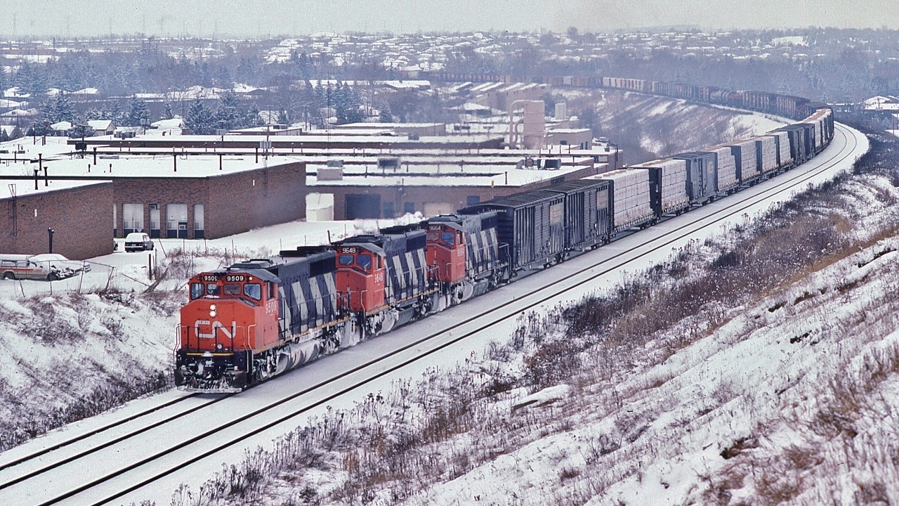 While awaiting VIA #1, CN extra 9509 west leads two sisters ( 9648 9664) 'elephant style' towards Mac Yard.


   The ubiquitous GMD 1974-6 built  GP40-2L(W), CN owned 278 examples.


   At Yonge Street, January 17, 1987 Kodachrome by S.Danko
