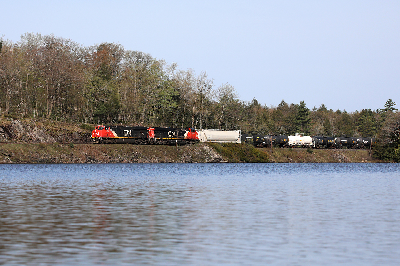 Summer is in the air as 314 slides by Lawson bay Rd approaching Dock Siding. Water, rocks, and trees are the hallmarks of this area...an incredible challenge to the builders 130 years ago.