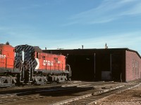 At Prince Albert, CP’s shop facilities were modest compared with CN’s roundhouse off to the south, a simple four-track engineshed, utilized every night in the old way of storing engines inside, even an old reflector-and-bulb headlight for area illumination.  Here, two lightweight RS-23s await their next assignment.  This is all completely history now, very difficult to know a railway yard was even there.