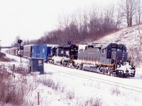 I remember this day well. A heavy winter storm had just finished passing through Southern Ontario leaving a good dumping of snow behind. CN train 396 has spent much of its trip from Chicago the previous day battling the weather, with the snow accumulation on the units telling g the story. CN’s SD40”s models seemed a dime a dozen back them but certainly not anymore, And consist like this are missed deeply today. Here the train is passing the old water over rail Inspection shed. 