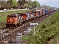 CN 9672, former GO Transit 705 / 9813 leads a GTW GP38, another CN GP40 and CN/GTW “Operation Lifesaver” GP40 6401 on a westbound at Hardy in Brantford’s west end. This was a nice location to railfan until the trees filled everything in eliminating most shots. The train had stopped for a half hour to fix a bad hose bag and are back in their way to Paris where they will drop the long cut of tank cars for Railink to forward to Nanticoke in the days to come. 