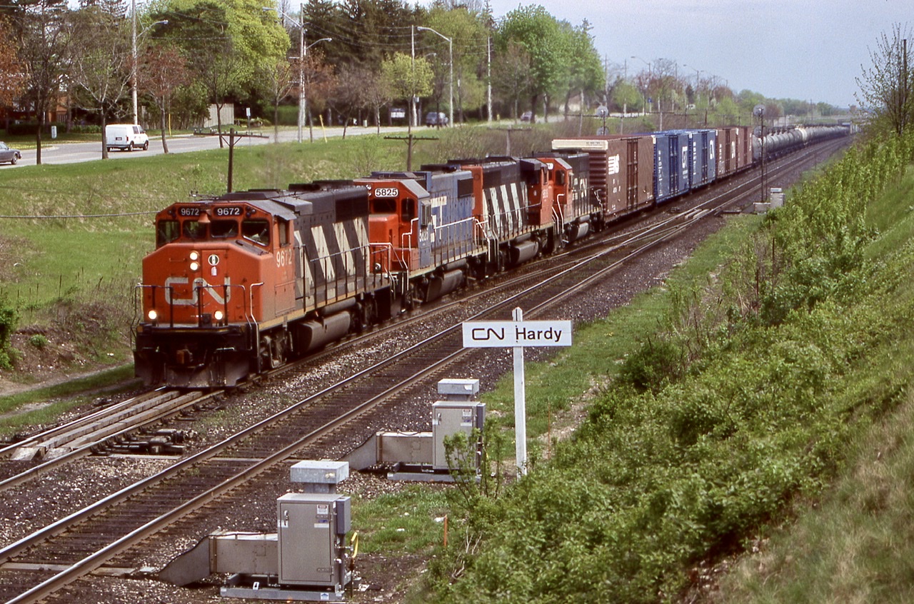 CN 9672, former GO Transit 705 / 9813 leads a GTW GP38, another CN GP40 and CN/GTW “Operation Lifesaver” GP40 6401 on a westbound at Hardy in Brantford’s west end. This was a nice location to railfan until the trees filled everything in eliminating most shots. The train had stopped for a half hour to fix a bad hose bag and are back in their way to Paris where they will drop the long cut of tank cars for Railink to forward to Nanticoke in the days to come.