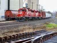 The light drizzle has tapered off as H24 finishes its drop at Ardent mill. The switch used to access the mill appears to be on the list of being replaced soon by a new “lift frog” type. This is marked on the rail. This type of switch should reduce maintenance costs and wear to wheel flanges on the mainline, while it forces cars on the spur to hop over the rail at a slow speed.  While the train  and its run of the mill ECO’s were not anything special this day, I couldn’t resist catching them alongside the new switch. Many of hoped the switch was dropped here for connecting the old ADM spur back to the mainline but I’m pretty sure this sadly is not the case. Interesting too is that all the rail for the back track including the diamond are still intact within the Ardent facility, unfortunately not connected or used since Reid’s owned the property. The Canada grain car was a nice catch this day as well considering they are a dying breed these days. 