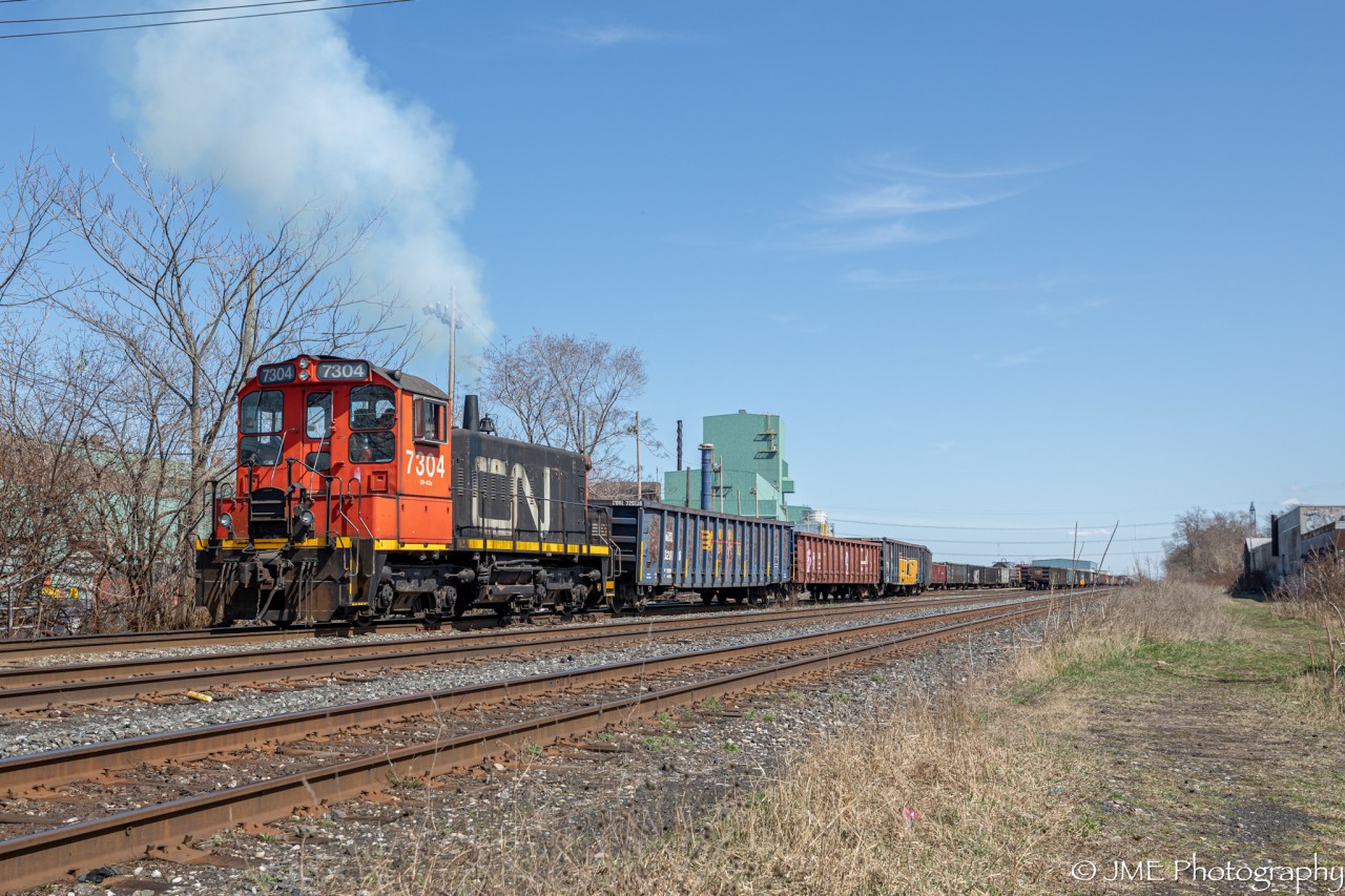 The Parkdale Yard switcher is seen puffing smoke, as it shoves a cut of Gondolas back into the yard track. This unit is one of 3 CN SW1200’s left in existence on CN’s active roster, and it’s such a beauty to see this one still working away.