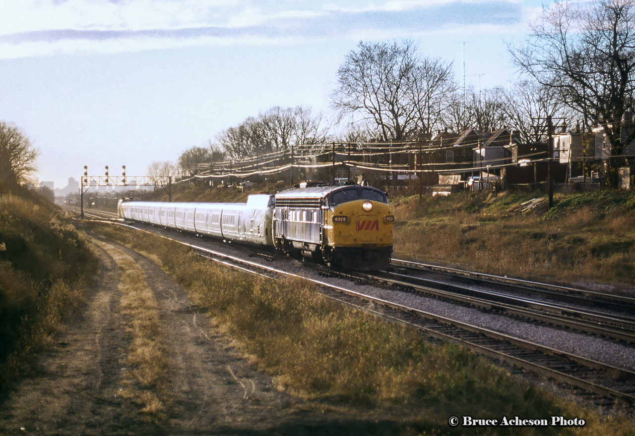 Turbo equipped train 66 seems to have run into some mechanical problems, needing help from FP9A 6525 on the approach to Danforth, about to duck under Main Street.  The scene is very different compared to what Doug Page shot almost 20 years earlier.