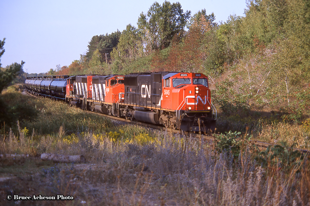 An SD75i and a pair zebra geeps lead a string of tanks westbound on the Halton at mile 30.  Of these three, only the 9650 has left the CN roster, now working as Vermont Railway 310.