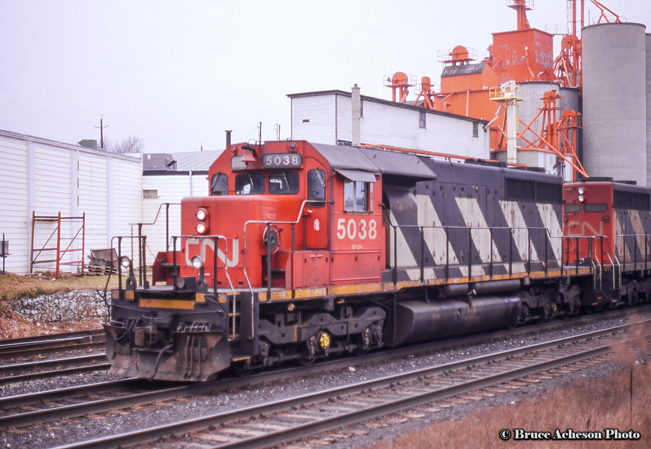 A pair of standard cab SD40-2s sit on the point of an eastbound at London East near the elevator.  5038 would be destroyed in a collision at Mont-Saint-Hilaire, QC in December 1999, while 5024 was sold to the BNSF in 1999 and rebuilt as BNSF 7327, renumbered BNSF 6987 around 2007, and finally to Webb Asset Management as WAMX 4165.