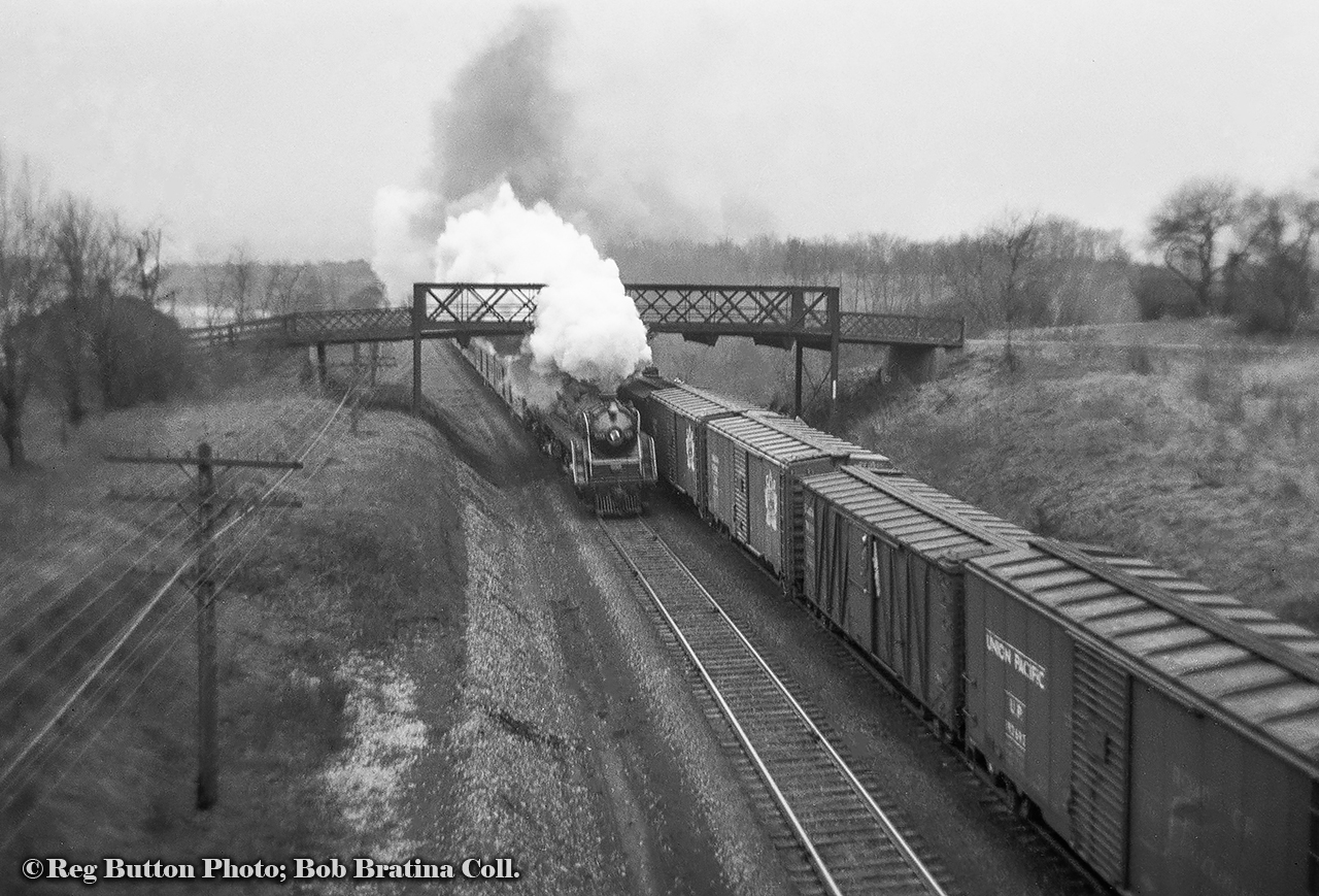 Looking west from Plains road, an eastbound passenger train, led by one of the CNR's U-1-f bullet-nosed Mountain types, passes under Spring Gardens Road bridge, now the Royal Botanical Gardens footbridge.