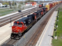 A perfect Sunday in May afternoon finds a power mix of CN 2588 (C44-9W), CN 5653 (EMD SD75I) and CN 8815 (EMD SD70M-2) leading an extremely long intermodal. This mix is resuming its journey westward after a short crew change at Belleville ON.  Photo was taken from the walkover at the Belleville, VIA Station looking eastbound over the yard.  In the background an idle CN 2989 (GE ES44AC) waits with a string of auto racks.