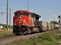 One of CN's many double stack container trains roars over the south switch at Suez, Ontario on June 16, 2016.  DPU CN 2840 brings up the markers of the train.   