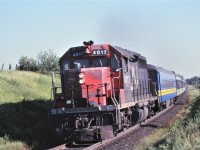 CN's last GP40, 4017, leads the Barrie commuter train 169 a mile or so north of Maple, Ontario on June 25, 1979.  The 4017 has seen better days and is now sporting two different number boards.  The 4017 along with the 4016 were regeared for passenger service.