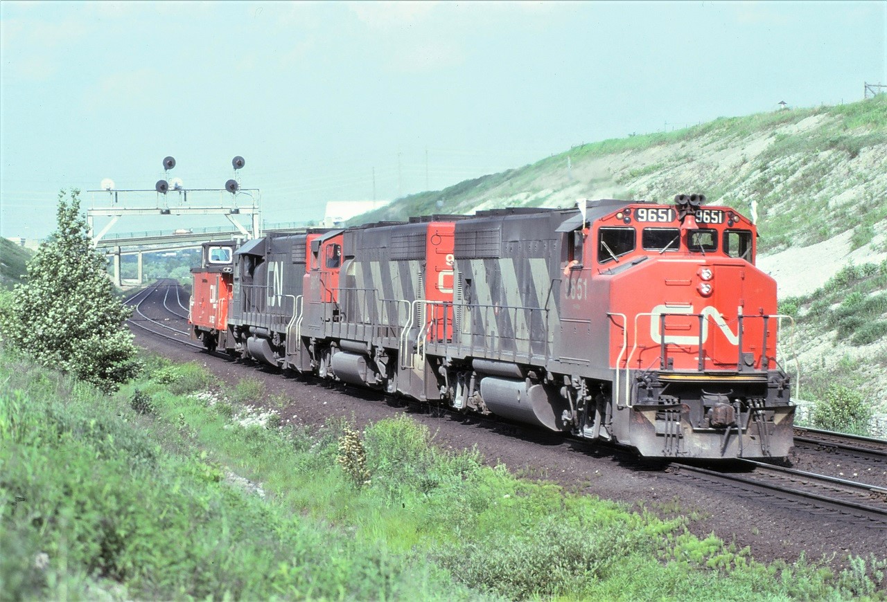 Running van hop (or caboose hop, if you prefer), CN 9651 9654 and 5529 and their caboose head west on the York Sub just west of Yonge Street after setting off 50 or so cars of rock at Millikens.