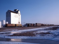 When I lived in Winnipeg, a favourite train-watching activity was to follow CN's Emerson turn south to the interchange with Burlington Northern and Soo Line in Noyes, Minnesota. Provincial highway 75 closely follows the Letellier sub and train speeds allowed one to get several photos in each direction. Normally, you could also catch CP's train interchanging with the BN and SOO (in the era before CP took over the SOO) and until about 1983, Burlington Northern Manitoba would also run their own train--five trains from five railroads for an hour our so in the village of Noyes!

This is the last shot of the day from one of those trips--GMD1s 1028 and 1054 bringing 16 cars and the van home...almost 40 years ago, now.