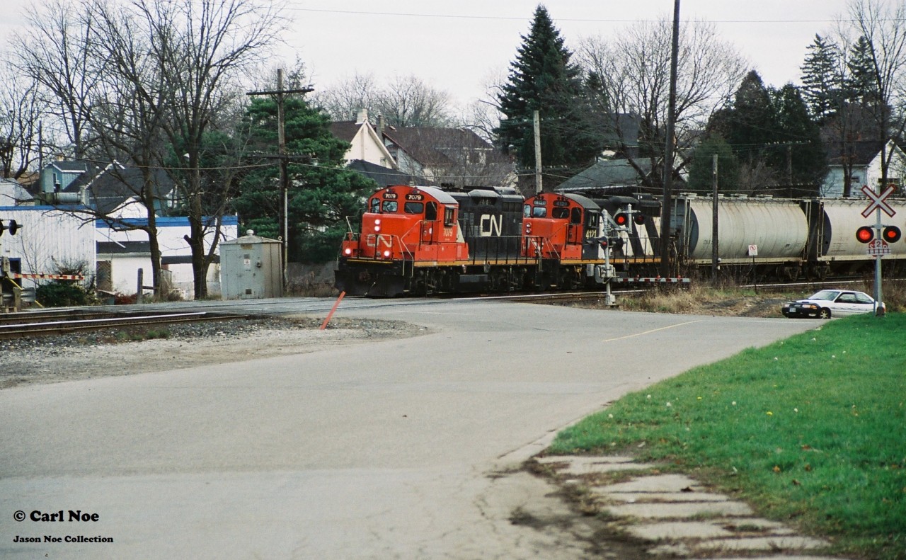 A pair of CN GP9RM’s 7079 and 4121 leads a local train westbound over the Broadway Street crossing in Paris, Ontario on CN’s Dundas Subdivision as they head to London. This was likely CN local 585 returning west after working industries in Brantford.