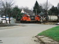A pair of CN GP9RM’s 7079 and 4121 leads a local train westbound over the Broadway Street crossing in Paris, Ontario on CN’s Dundas Subdivision as they head to London. This was likely CN local 585 returning west after working industries in Brantford. 